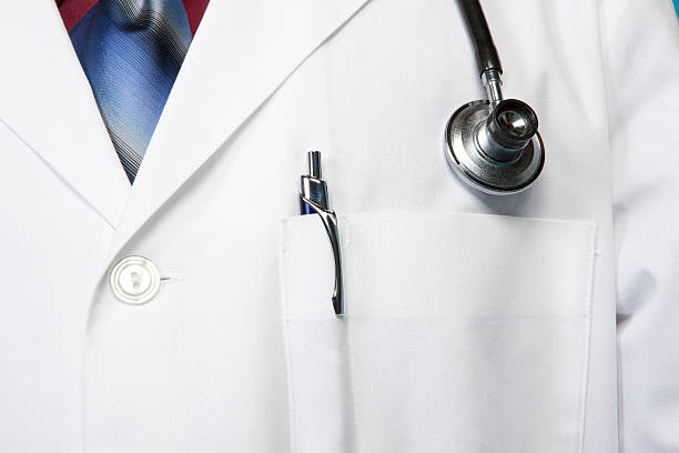 Close-up of a doctor's lab coat with stethoscope.View More.